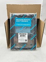 Closed shipping carton opened to show stacked Gumdrop clamshell cases in individual packaging