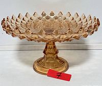 Front view of amber diamond point depression glass pedestal cake stand