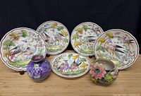 Group shot showing five Chelsea plates and two vases