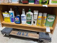 Shelf with various cleaning products bottom row