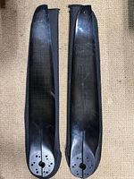 Two carbon fiber paramotor blades side by side showing overall shape and finish