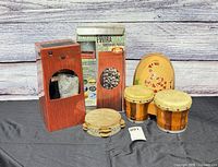 Full lot showing fountain tower, bongos, tambourine, guiro, and product box