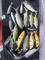 Full assortment of faux fish laid out on black cloth