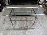 Full view of glass top table with both extension leaves retracted