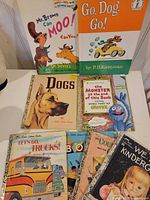 Group of seven children’s books laid out and standing for full lot view
