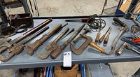 Overall view of assorted heavy duty hand tools on shelf