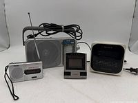 All four electronic items grouped together showing fronts, antennas and cords