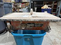 Front view of Ridgid wet tile saw showing brand plate and overall wear