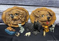 Full lot showing two wall plaques and seven dog figurines