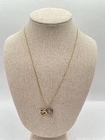 Full view of necklace on display bust showing chain length and both heart pendants