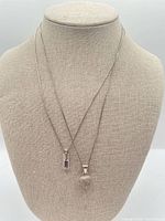 Both sterling silver necklaces displayed on bust