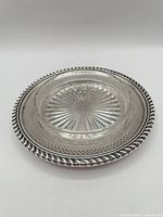 Overall view of assembled butter dish showing silver tray and glass liner