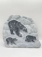 Front view showing bear relief carved in grey marble plaque