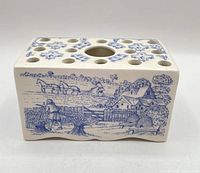 Front view showing blue country scene and top hole arrangement