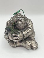 Front view of ornament showing Hagrid figure, baby dragon, and ribbon
