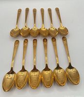 Full set of 12 gold-plated presidential teaspoons shown front view