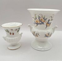 Both urn vases side by side showing size difference and patterns