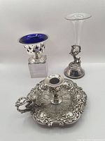 Group shot of chamberstick, cobalt lined sugar bowl, and figural bud vase