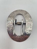 Front view showing ornate Art Nouveau scroll engraving