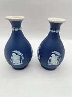 Frontal view of both vases showing relief decoration