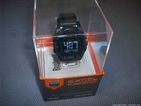 Watch inside clear retail box showing Bushnell Excel branding