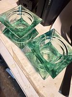Two green square glass candle holders top view
