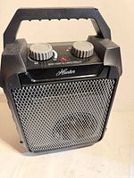Front view of Hunter space heater showing mesh grille and carry handle