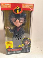 Front of boxed Interactive Edna figure showing character, branding, and Try Me feature.
