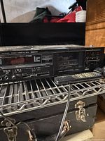 Front view of JVC stereo receiver with remote and cords visible