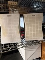 Front view of the two RCA bookshelf speakers on a shelf