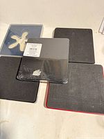 Five square Sizzix Stampin’ Up! Bigz dies on tabletop, one still factory sealed