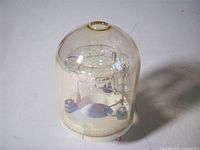 Front view of glass vacuum tube showing serpentine internal electrode and dome envelope