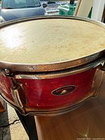 Front view of red Winston snare drum showing badge and hardware