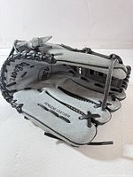 Open palm view showing grey leather, black lacing, model number 4361 and genuine leather stamp