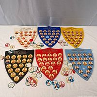 Overview of six team shields with scattered coins