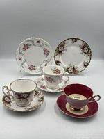 Full view of two trios and extra cup & saucer
