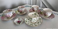 Group view of all teacups, saucers and small dish