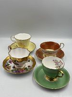 Group shot of the four teacups and saucers
