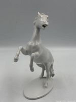 Front view of white porcelain rearing stallion figurine