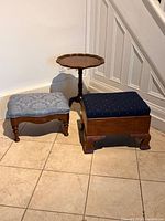 Overall view of two footstools and tilt-top table