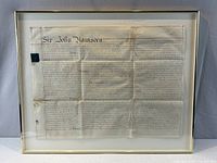 Full view of framed indenture behind glass