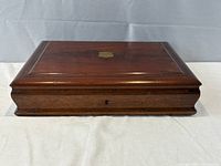 Closed wood case with shield cartouche and keyhole