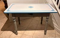 Full view of table front, enamel top visible