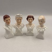Front view of four white porcelain miniature busts