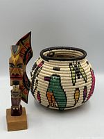 Basket and totem pole side by side