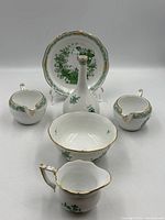 Full set: plate on stand, bud vase, three creamers, sugar bowl