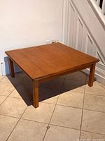 Full view of square teak coffee table