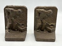 Front view showing both brass bookends with foundry worker relief