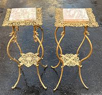 Both gilded metal stands side by side showing full form and marble tops