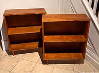 Front view of both teak shelving units